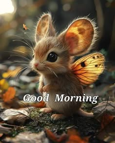 a little mouse sitting on top of leaves with the words good morning in front of it