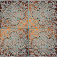 four square tiles with an intricate design on the top and bottom, all in different colors