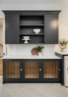 a washer, dryer and cabinets in a room