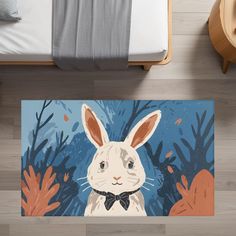 a bed room with a neatly made bed and a rug on the floor that has an image of a rabbit wearing a bow tie