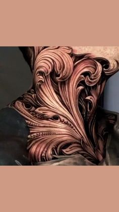 the back of a man's neck covered in intricate tattoos