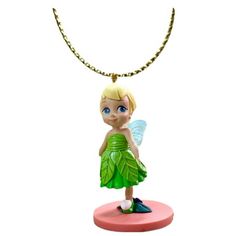 a small figurine with a green dress on top of a pink base and gold chain