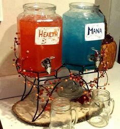 two jars filled with liquid sitting on top of a counter