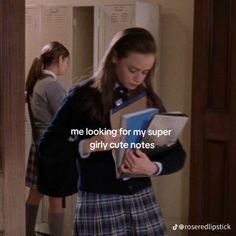 a girl in a school uniform holding a binder and looking down at her notebook