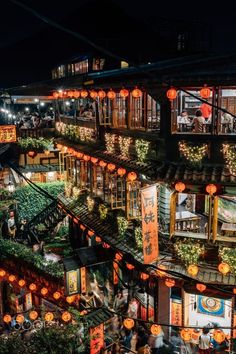 an aerial view of many buildings with lanterns on them