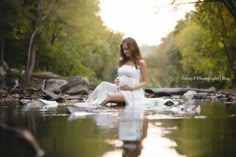 a pregnant woman is sitting in the water