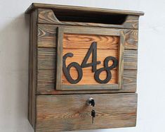 a wooden mailbox with the number 488 on it