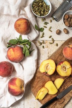 some peaches and nuts on a cutting board