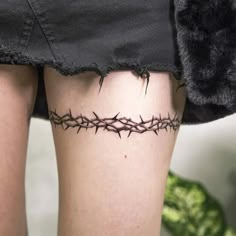 a woman's thigh with barbed wire on it