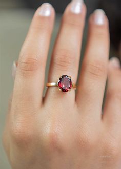 Our Garnet Gemstone Ring features a deep red faceted oval garnet set in a classic four prong setting. This January birthstone ring is Handmade in 925 silver base with a thick coating of nickel free 18k Gold Vermeil. D E T A I L S Stone size - Large - 10mm x 8mm Band size - 2mm Material: 18k thick gold vermeil over 925 sterling silver, genuine red Garnet gemstone Birthstone Month: January S H I P P I N G * Processing time - 2 business days, usually ships the next day. We are closed on Saturdays a Silver Rings With Red Stone, Birthstone Gold Ring, Gold Ring With Ruby Stone, Ruby Gemstone Ring, Oval Garnet Ring, Gold And Garnet Ring, Gold Stone Rings For Women, January Birth Stone Rings, Garnet Silver Ring