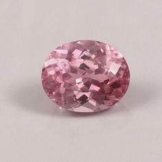 an oval shaped pink diamond on a white background