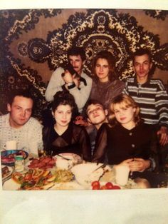 a group of people sitting around a dinner table