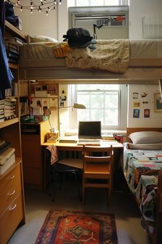 two beds in a dorm room with a desk and computer on the bottom bunk bed