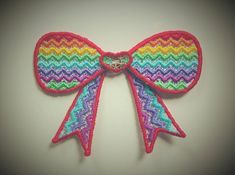 a close up of a colorful bow on a wall