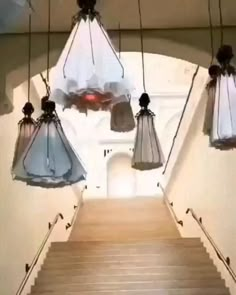 some lights hanging from the ceiling above stairs