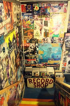 an old record shop with various records on the wall and posters all over the walls