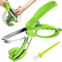 the green scissors are being used to cut leaves