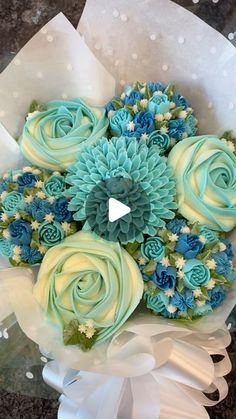 a bouquet of blue and white flowers sitting on top of a table