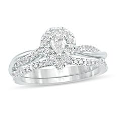 This 1/2 ct. t.w. diamond frame bridal set in 10K white gold features a 1/8 ct. pear-shaped diamond center stonetwist shank engagement ring. A coordinating wedding band completes the look. Silver Pear-shaped Diamond Ring For Wedding, Pear-shaped Silver Diamond Ring For Wedding, Teardrop White Gold Diamond Ring For Wedding, Teardrop White Gold Diamond Wedding Ring, White Gold Teardrop Diamond Ring For Wedding, White Gold Pear-shaped Diamond Wedding Ring, Pear Shaped Diamond Wedding Ring In White Gold, Pear-shaped Diamond Wedding Ring In White Gold, Teardrop Brilliant Cut Ring For Wedding