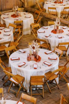 the tables are set with white linens and place settings for guests to sit at