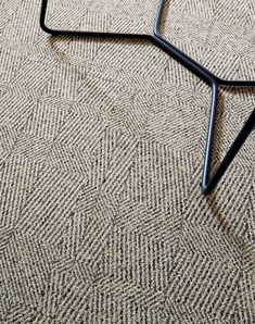 a black metal frame sitting on top of a carpet