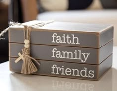 two wooden boxes with words on them sitting on a table