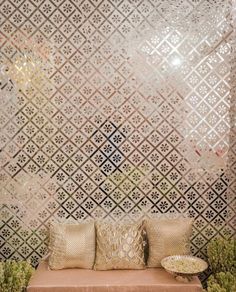 a couch sitting in front of a wall with decorative tiles on it's sides