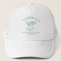 a white trucker hat with the bride club logo and two glasses of wine on it