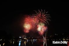 fireworks are lit up in the night sky over water