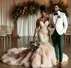 a man and woman in formal wear standing next to each other on a dance floor