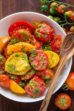 a white bowl filled with tomatoes and pesto