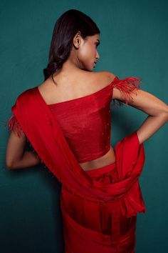 Red pre-draped plain saree in satin silk base with dangling beads on hem. Paired with off shoulder padded blouse with all over french knots bloom embroidery, feather detailing on the sleeves and embroidered belt.
Components: 3
Pattern: Embroidery
Type Of Work: French Knots
Neckline: Straight Neck
Sleeve Type: Off Shoulder
Fabric: Satin Silk
Color: Red
Other Details: 
Padded blouse
Length:
Saree: 43inches
Blouse: 15inches
Note: The gypsie tiara worn by the model is not for sale
Occasion: Sangeet, Silk Saree Blouse With Draped Sleeves, Silk Wedding Blouse With Draped Sleeves, Unstitched Silk Draped Choli, Draped Blouse For Diwali Evening, Draped Blouse For Evening Diwali Celebrations, Draped Evening Blouse For Diwali, Draped Blouse For Evening And Diwali, Silk Draped Blouse For Diwali, Diwali Draped Silk Blouse