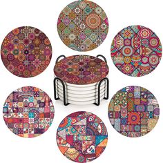 a set of four colorful plates with different designs on them, all stacked up in the same pattern