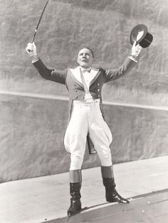 an old photo of a man holding two hats