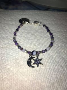 This bracelet is a Moon and Star Bracelet with purple beads, crystals, and silver accents, magnetic clasp with charm. I make all jewlery to order to let the customer customize color, size, and even charms. I appreciate your support! Thank you! Love and Light! If you require any special adjustments please message me. Standard bracelets are 7.5 inches. Handmade Purple Sterling Silver Beaded Bracelets, Spiritual Nickel-free Purple Beaded Bracelets, Purple Adjustable Celestial Jewelry, Adjustable Purple Celestial Jewelry, Spiritual Purple Crystal Bracelet With Spacer Beads, Purple Star-shaped Beaded Jewelry, Spiritual Purple Beaded Charm Bracelet, Moon And Star Bracelet, Purple Bracelets