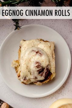 an eggnog cinnamon roll on a white plate