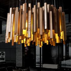 a chandelier made out of wood and lights hanging from it's ceiling