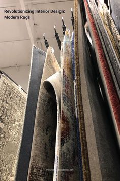 several rugs hanging up in a room