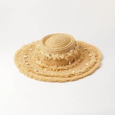 Embrace the sun while keeping cool and stylish with our Chic Raffia Sun Hat. Handcrafted from high-quality raffia, this hat is a must-have accessory for any beach goer or outdoor enthusiast looking to combine fashion with functionality. The elegant shell decoration adds a touch of seaside charm, making it a standout addition to your summer wardrobe. Key Features Sun Protection: Enjoy your day in the sun without the worry, as our hat offers excellent protection against harmful UV rays. Material: Made from 100% natural raffia, known for its durability and breathability. Design: Features a solid pattern with a casual style that complements any outfit. Seasonality: Perfect for spring and summer, providing both comfort and style in warm weather. Product Benefits Versatile Fashion: Its neutral c Beachy Sun Hat For The Beach, Beachy Sun Hat For Beach, Summer Sun Hat For The Beach, Summer Sun Straw Hat For Beach, Coastal Style Sun Straw Hat For Beach, Sun Straw Hat For Beach Vacation, Beige Sun Straw Hat For The Beach, Short Brim Panama Hat For Beach Vacation, Bohemian Fedora Straw Hat For Warm Weather