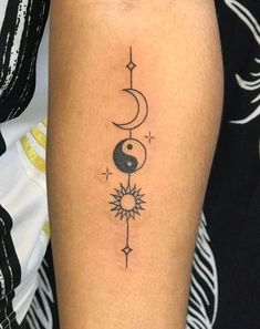 a person with a tattoo on their arm that has a sun and moon in it