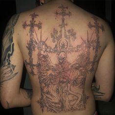 the back of a man with tattoos on his body and cross tattoo designs on his back