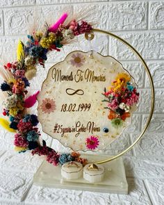 a wedding sign with flowers and feathers on it