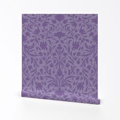 a purple wallpaper with an ornate design on the front and back side, against a white background