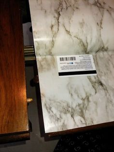 a close up of a marble counter top with a wooden box next to it on a table