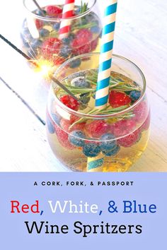 red, white, and blue wine spritzers in glasses with strawberries on the rim