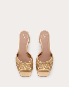 Valentino Garavani slide sandal in laminated nappa leather with Cornely embroidery and VLogo Signature decoration - VLogo Signature accessory in light gold finish - Block heel covered in laminated nappa leather - Heel height: 60 mm / 2.4 in. - Made in Italy Designer Gold Leather Sandals, Designer Gold Open Toe Sandals, Elegant Gold Open Toe Slides, Gold Leather Mules For Evening, Luxury Gold Mules For Party, Elegant Gold Slides For Spring, Chic Gold Open Toe Slides, Designer Gold Heels For Spring, Luxury Slides For Spring