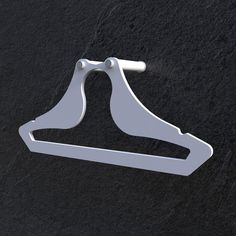 a pair of white clothes hangers on a black surface