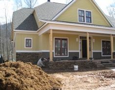 a yellow house is being built in the woods