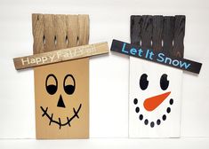 two wooden signs with faces on them that say happy fall and let it snow together