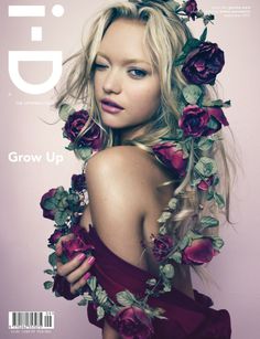 a woman with flowers in her hair and dress on the cover of a magazine,